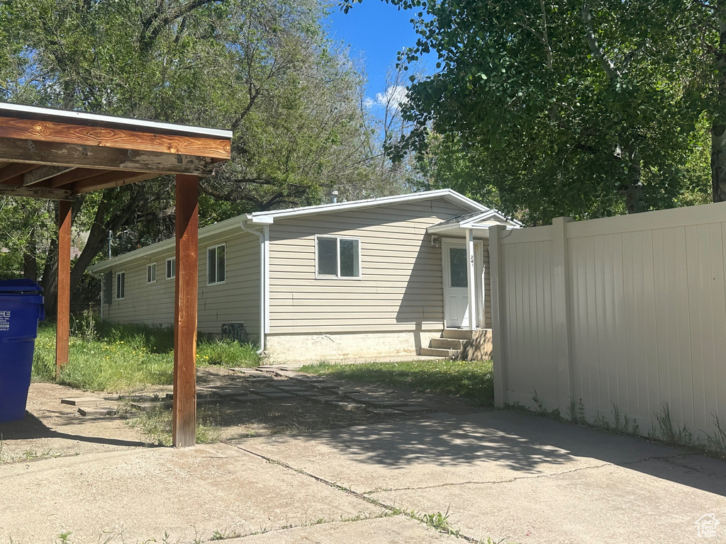 Exterior space featuring entry steps and fence