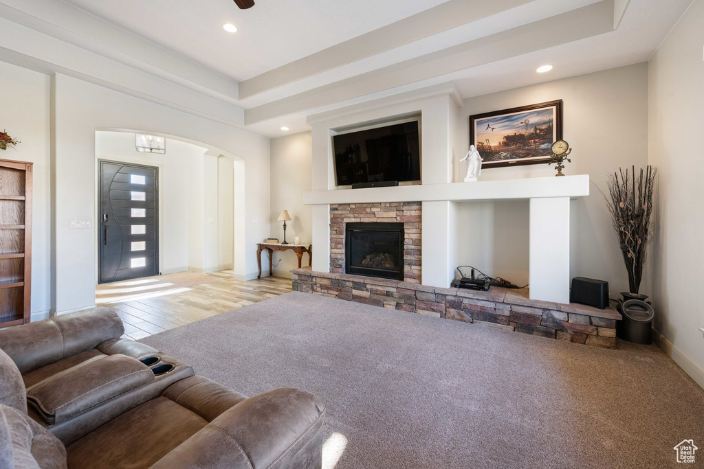 Living area featuring arched walkways, recessed lighting, and a fireplace