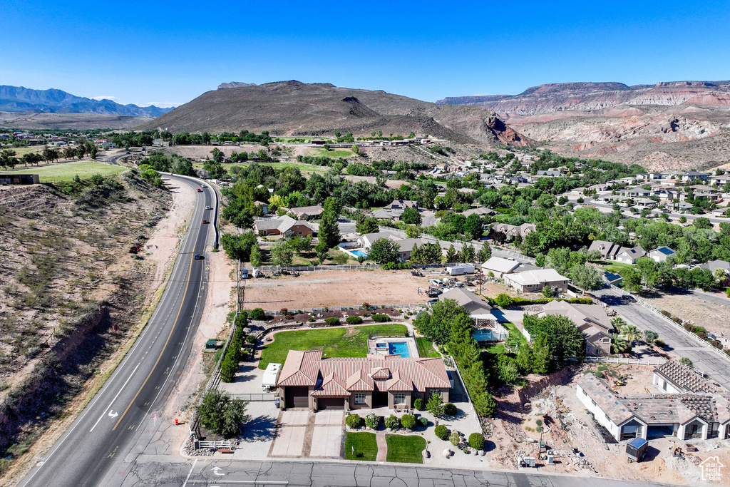 Aerial overview of property's location featuring mountains and nearby suburban area