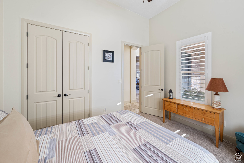 Bedroom with a closet and light colored carpet