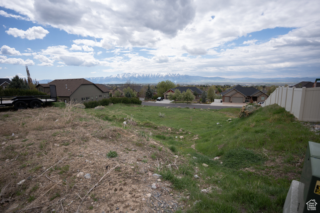 View of yard with a residential view, a mountain view, and fence