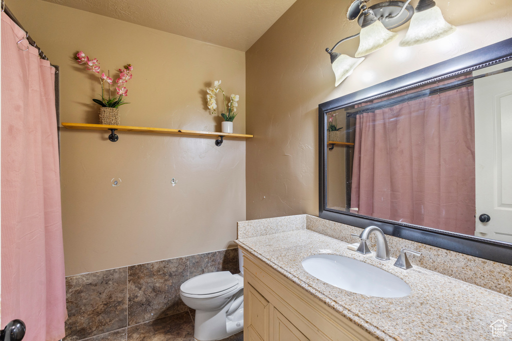 Bathroom featuring vanity and toilet