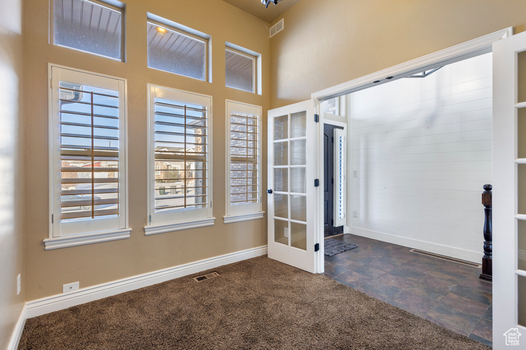 Interior space with a towering ceiling and french doors