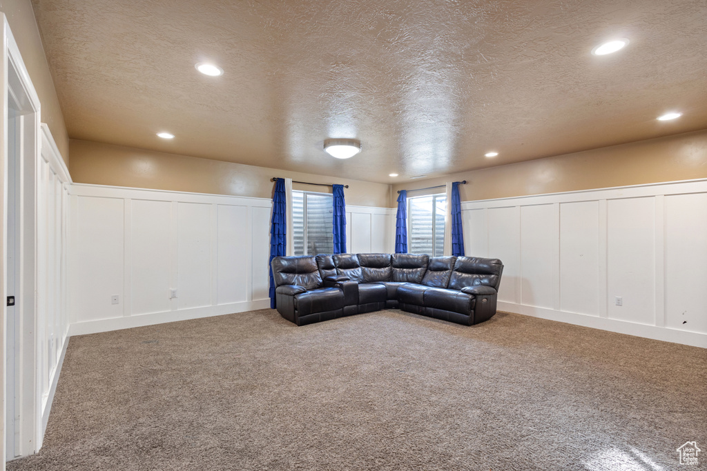 Living room featuring a textured ceiling and carpet