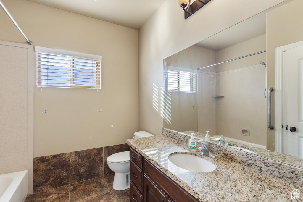 Full bathroom featuring vanity, shower / washtub combination, and toilet