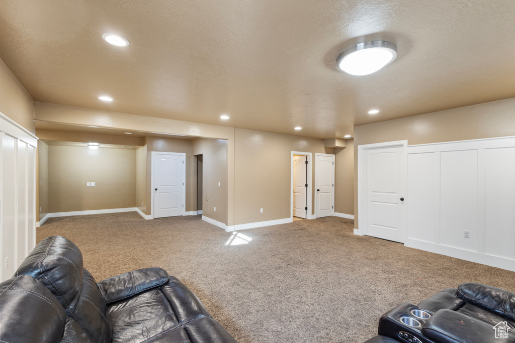 Living room with carpet and a textured ceiling