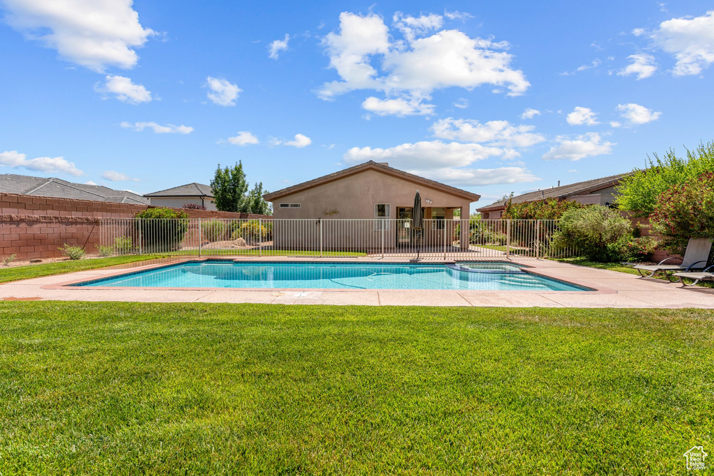 View of swimming pool featuring a patio and a pool with connected hot tub