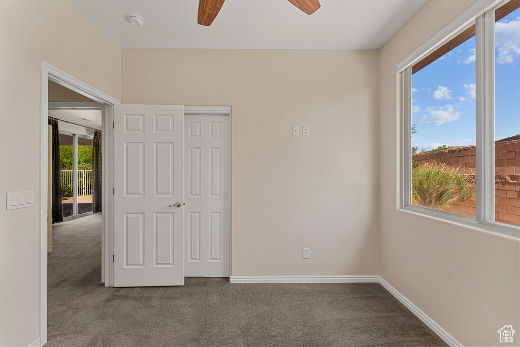 Unfurnished bedroom featuring carpet flooring, baseboards, and a closet