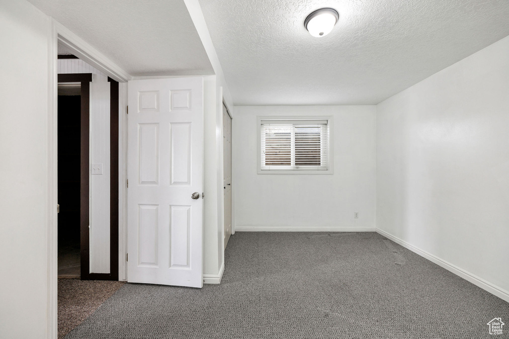 Unfurnished bedroom with carpet and a textured ceiling