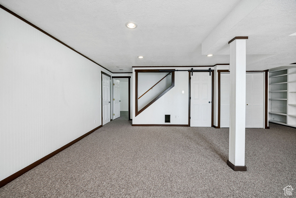 Basement featuring carpet floors and a textured ceiling