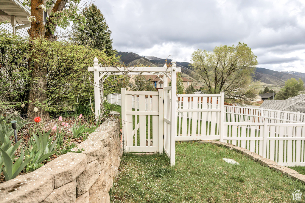 View of yard featuring fence and a mountain view