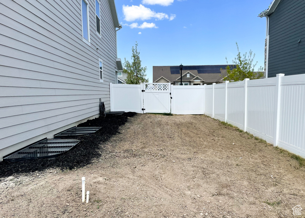 View of yard featuring a gate and a fenced backyard