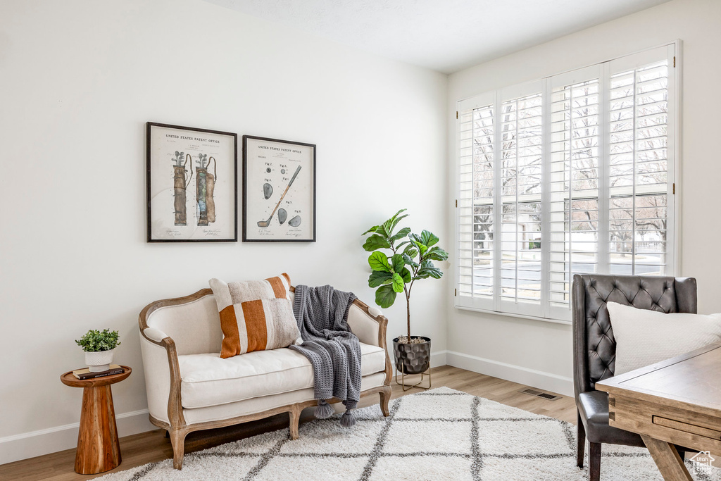 Office space with light hardwood / wood-style floors