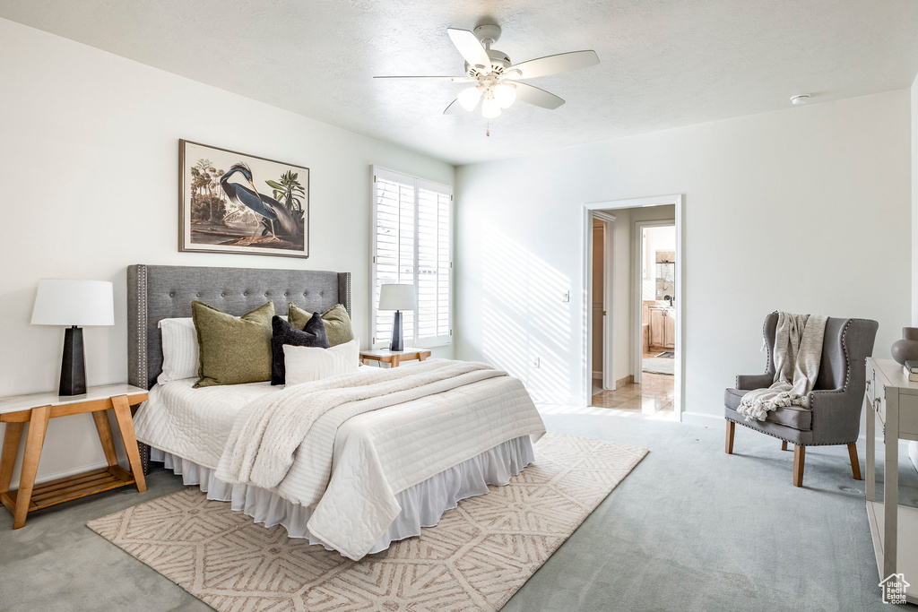 Carpeted bedroom with ceiling fan