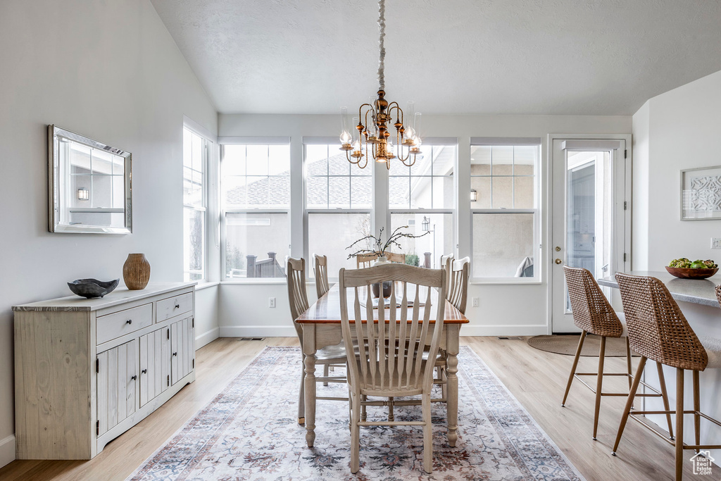 Dining space featuring light hardwood / wood-style flooring and a chandelier