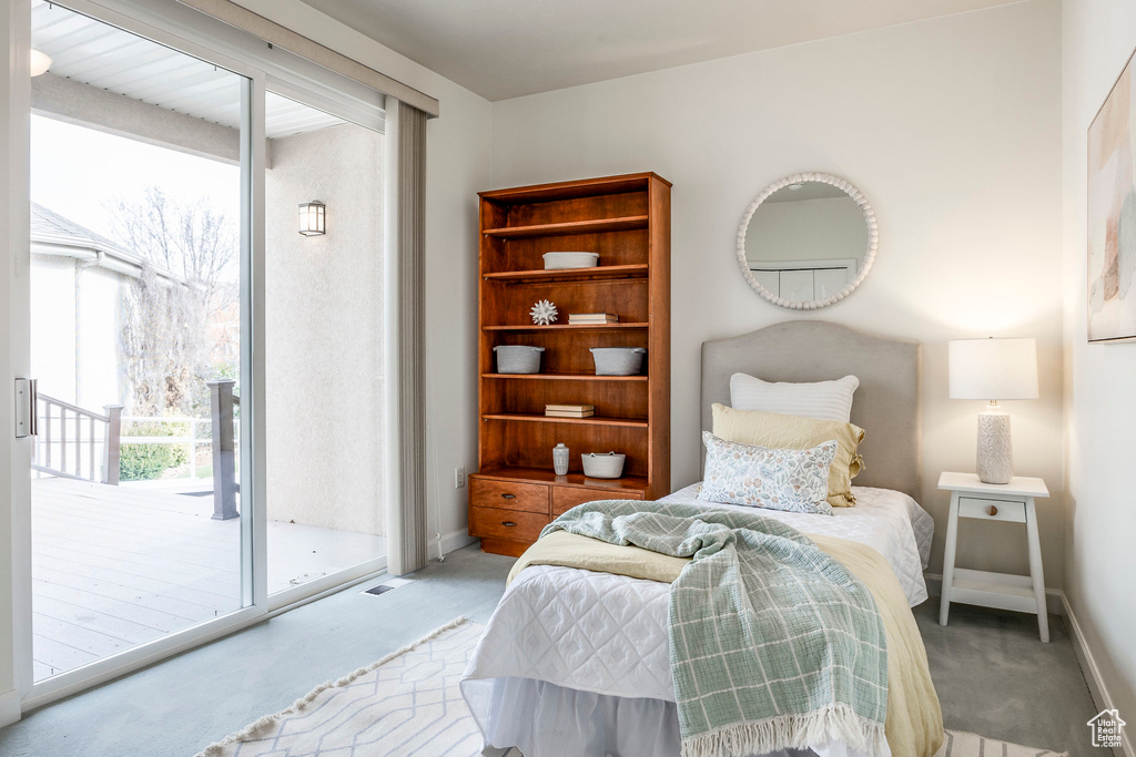 Bedroom with light carpet and access to outside