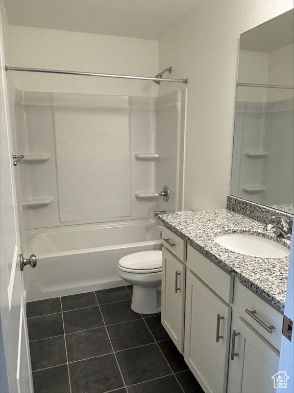 Full bathroom with vanity, tile patterned flooring, and washtub / shower combination