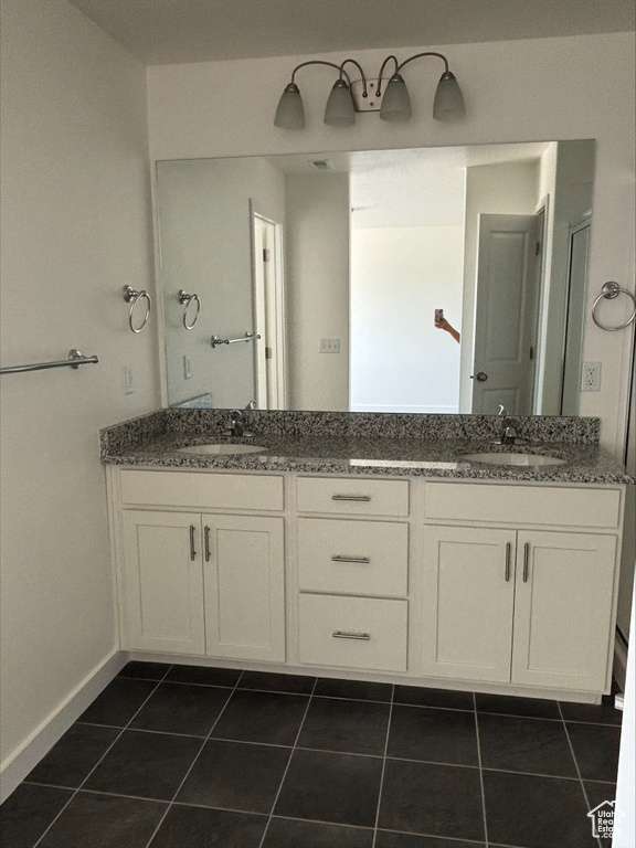 Full bathroom with double vanity and tile patterned flooring