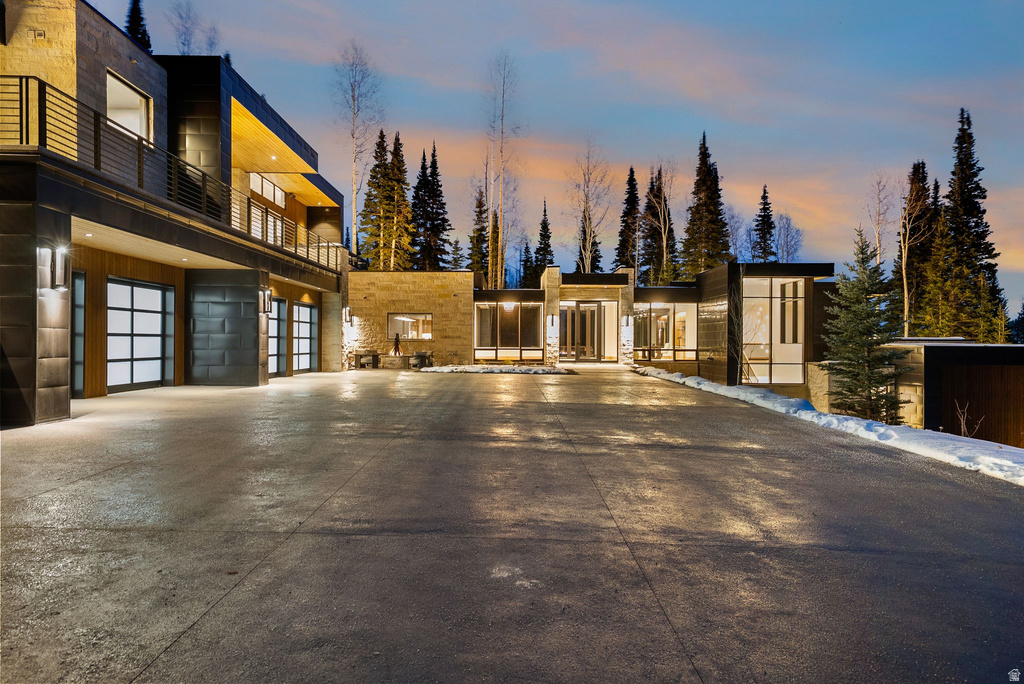 View of front of house featuring a balcony and driveway