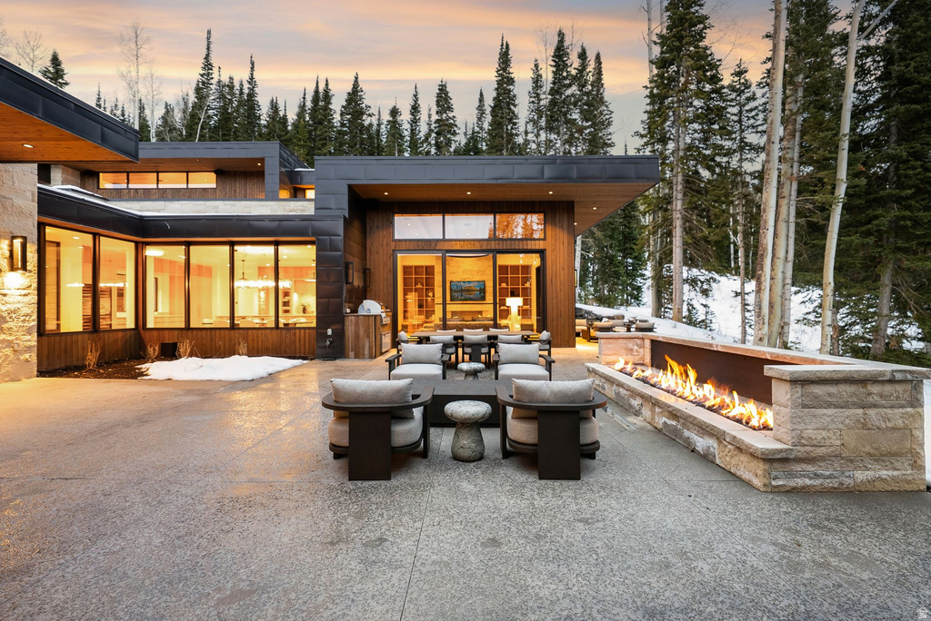 Snow covered property with a patio