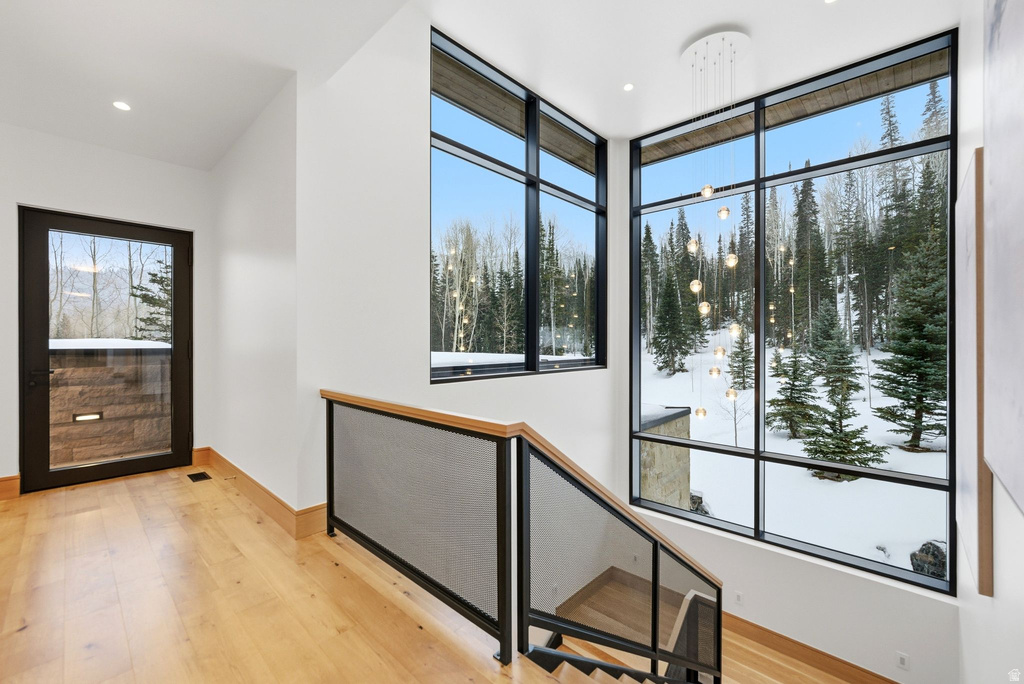 Foyer with light wood-style flooring and recessed lighting