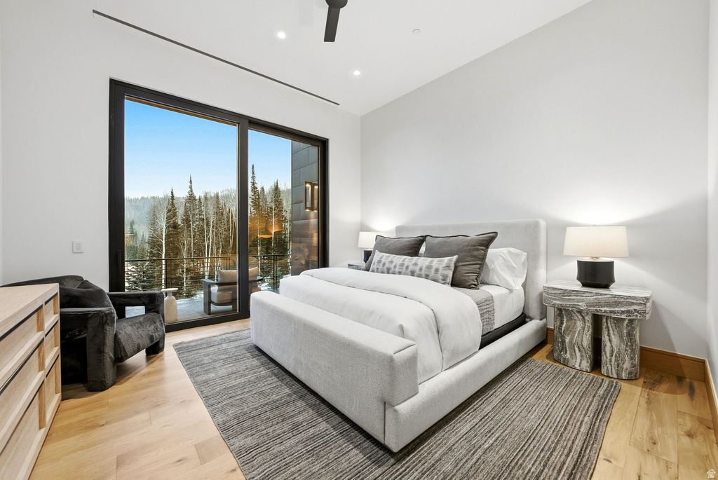 Bedroom with access to exterior, light wood-style floors, ceiling fan, lofted ceiling, and recessed lighting