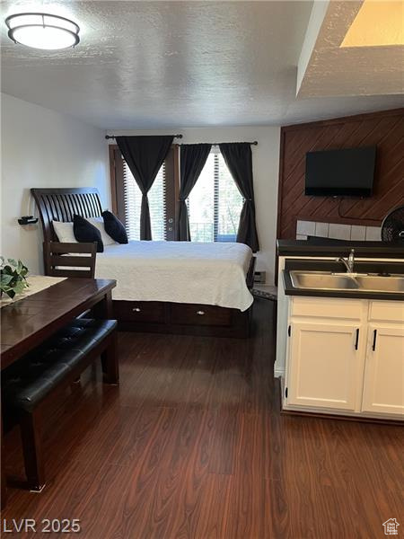 Bedroom with dark wood finished floors