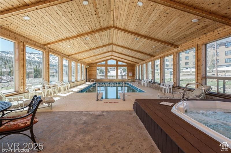Indoor pool featuring a jacuzzi