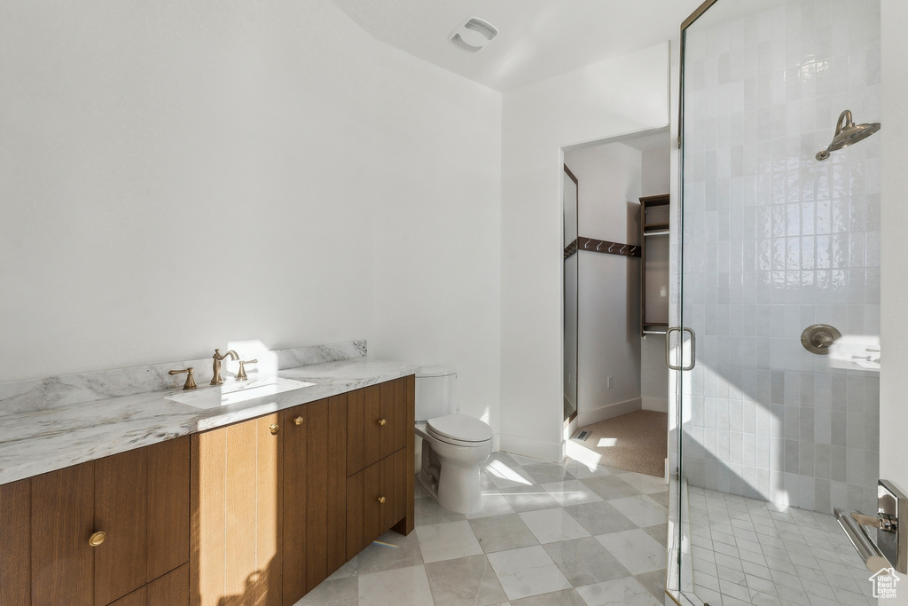 Bathroom featuring a stall shower and vanity