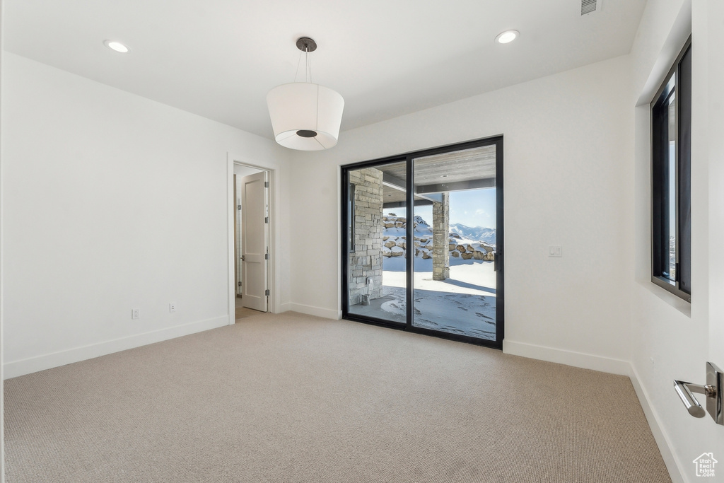 Spare room with light carpet and recessed lighting