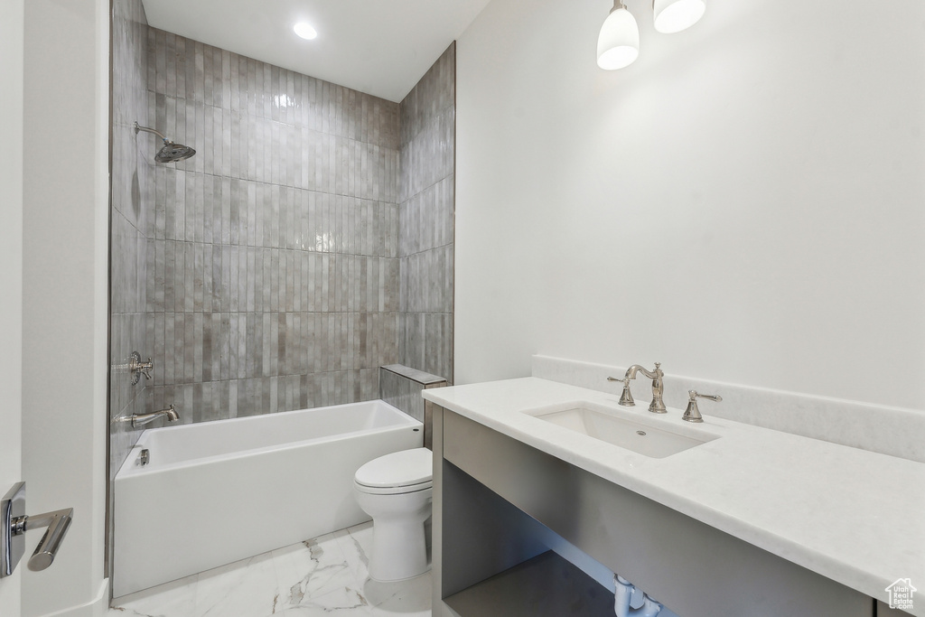Full bath featuring vanity, marble look tile flooring, shower / bathtub combination, and recessed lighting