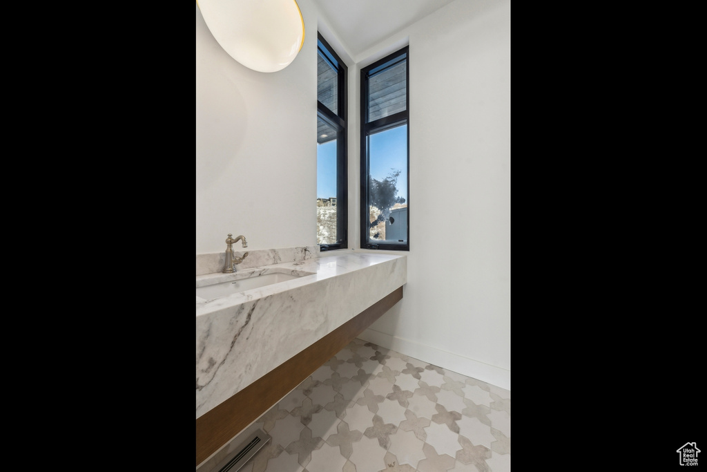 Bathroom with tile patterned floors and vanity