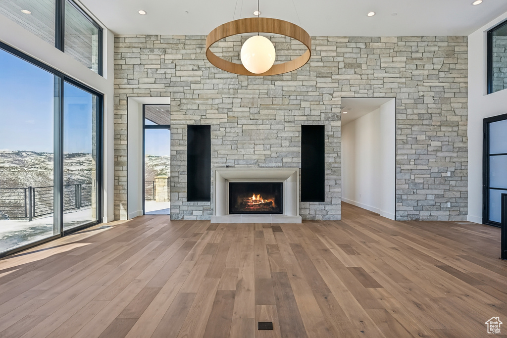 Unfurnished living room with a fireplace, wood finished floors, and recessed lighting