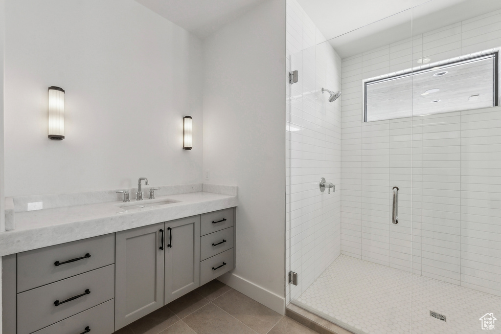 Bathroom with a stall shower, vanity, and tile patterned floors