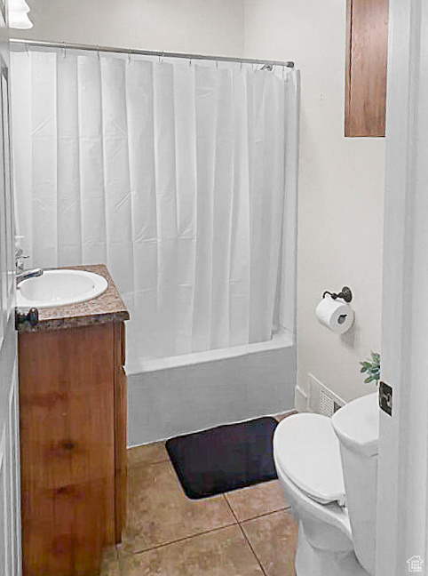 Full bathroom with shower / bathtub combination with curtain, tile patterned floors, toilet, and vanity