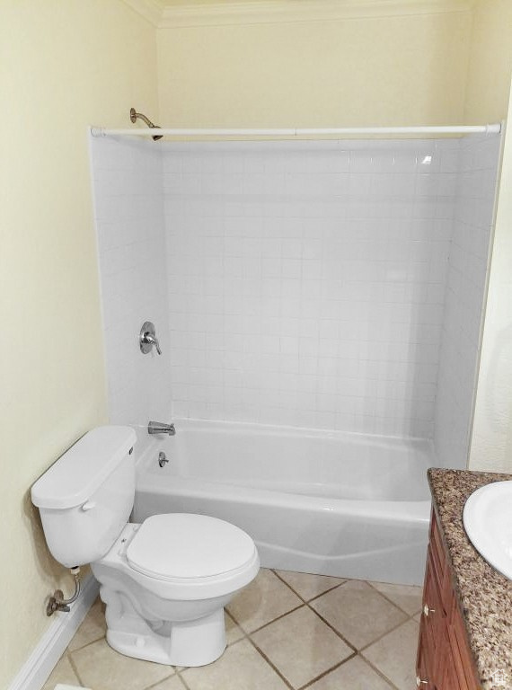 Full bathroom with vanity, tile patterned floors, toilet, and shower / washtub combination