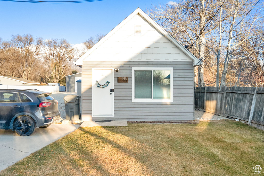 Bungalow-style house with a front lawn