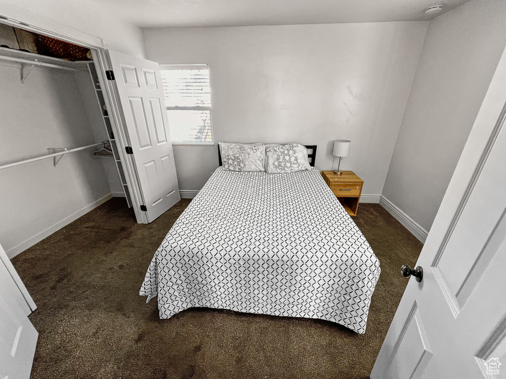 Bedroom featuring dark colored carpet