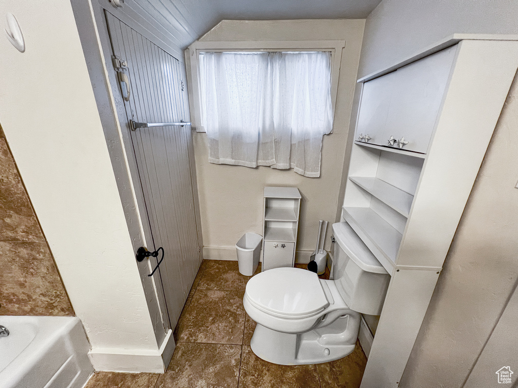Bathroom featuring a bath and toilet