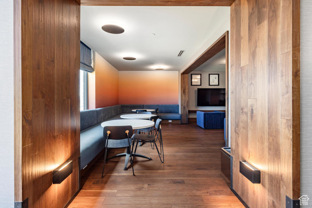 Dining space with dark wood-type flooring