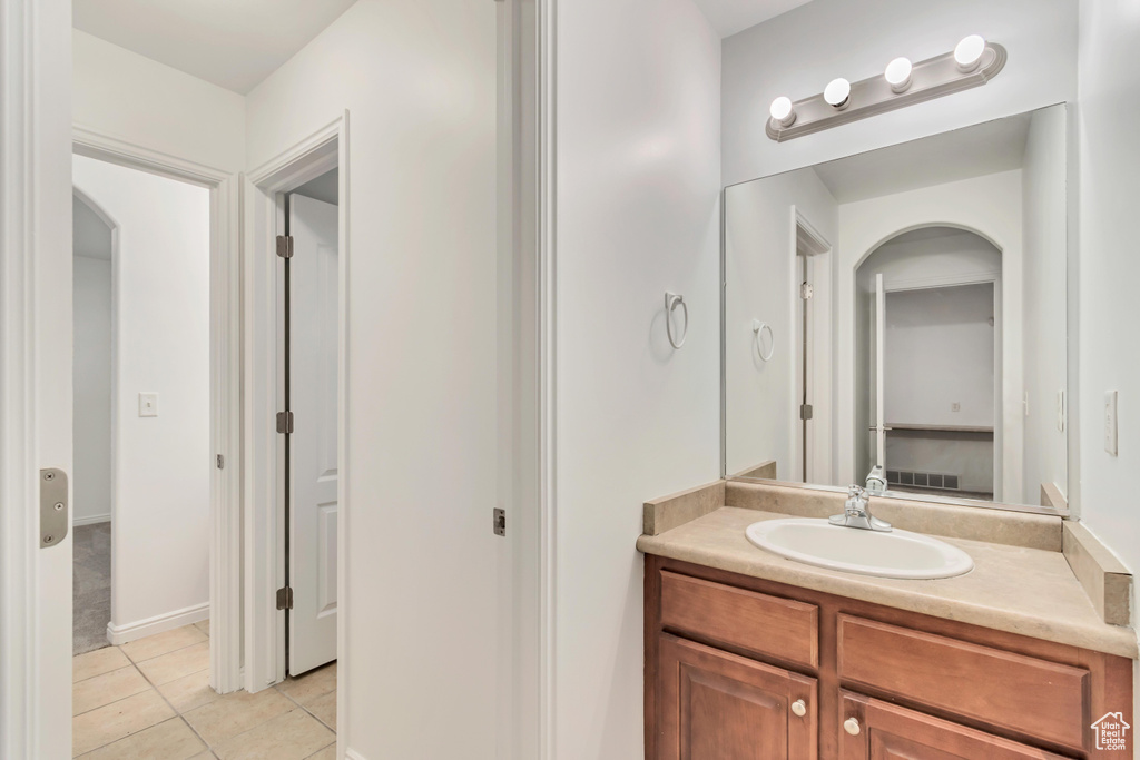 Bathroom with tile patterned flooring and vanity