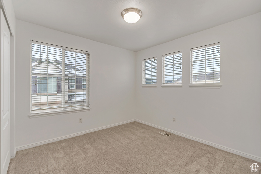 Spare room featuring light colored carpet