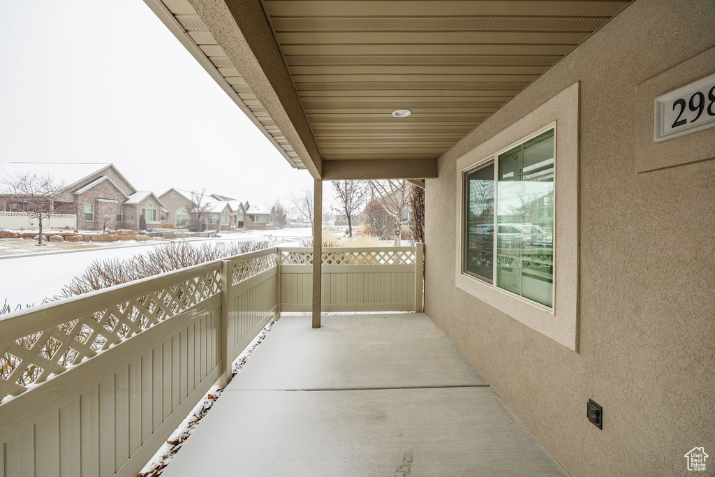 View of snow covered back of property