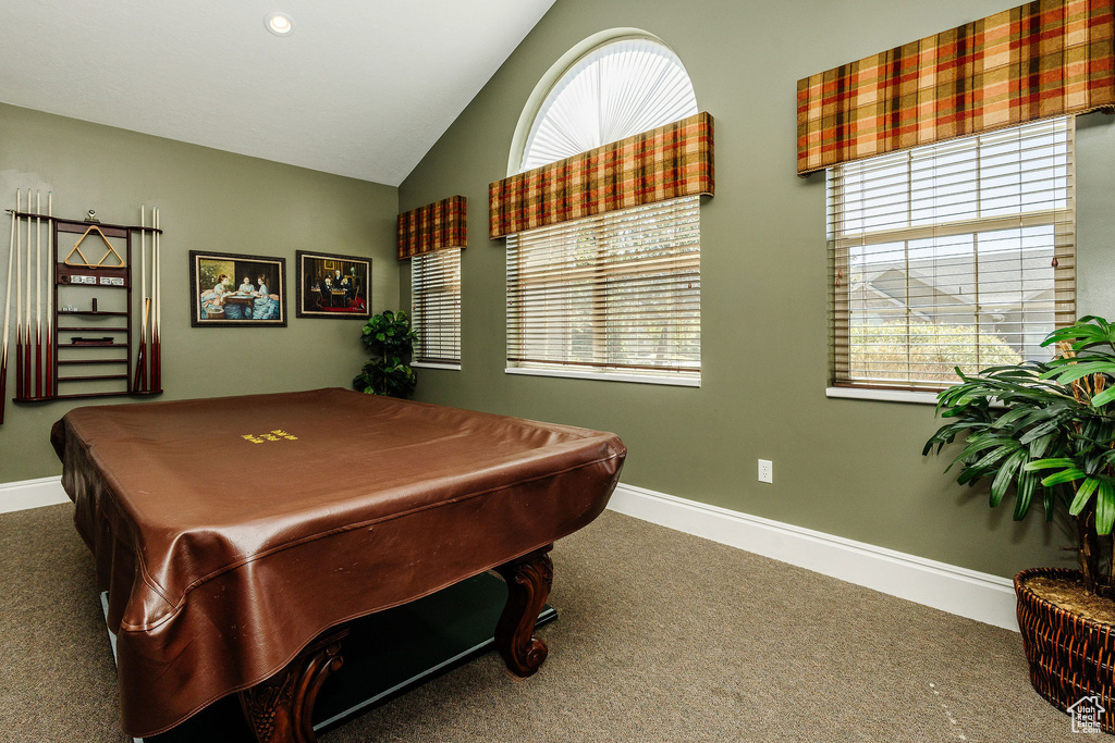 Rec room with dark colored carpet, vaulted ceiling, and pool table