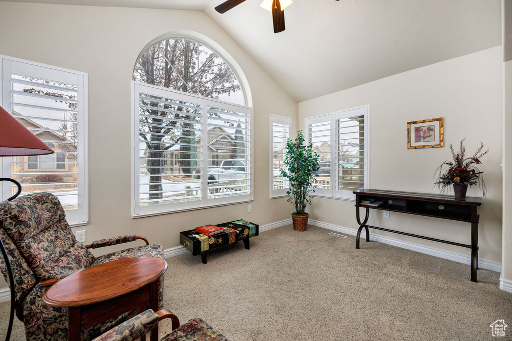 Sitting room featuring vaulted ceiling, carpet flooring, and ceiling fan