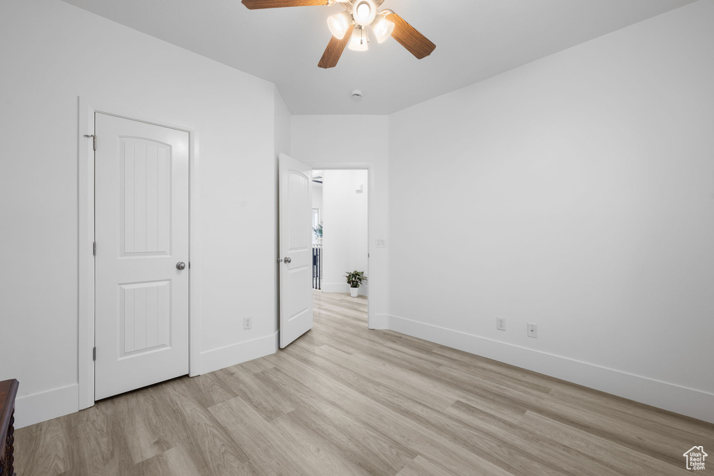 Unfurnished bedroom with light hardwood / wood-style floors and ceiling fan