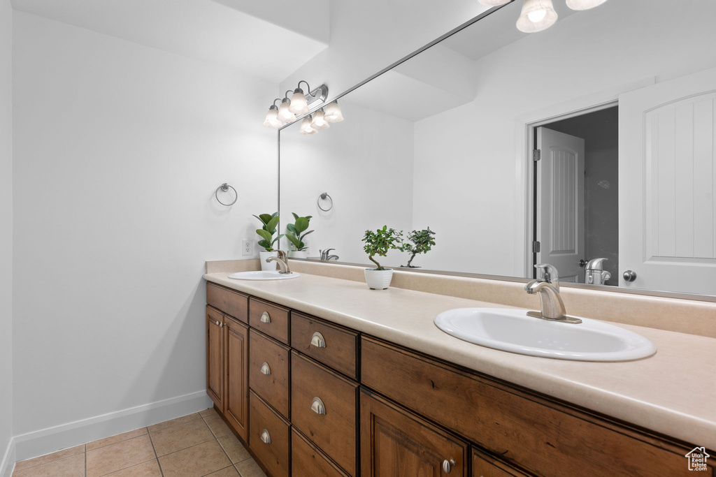 Bathroom with tile patterned flooring and vanity