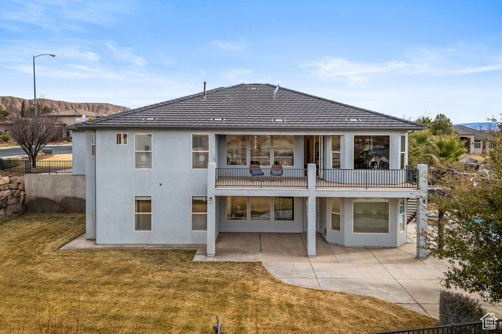 Back of house featuring a yard and a patio