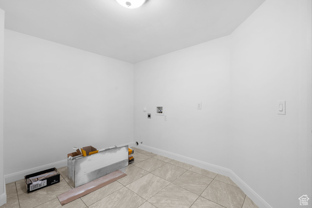 Laundry room with gas dryer hookup, hookup for an electric dryer, washer hookup, and light tile patterned floors