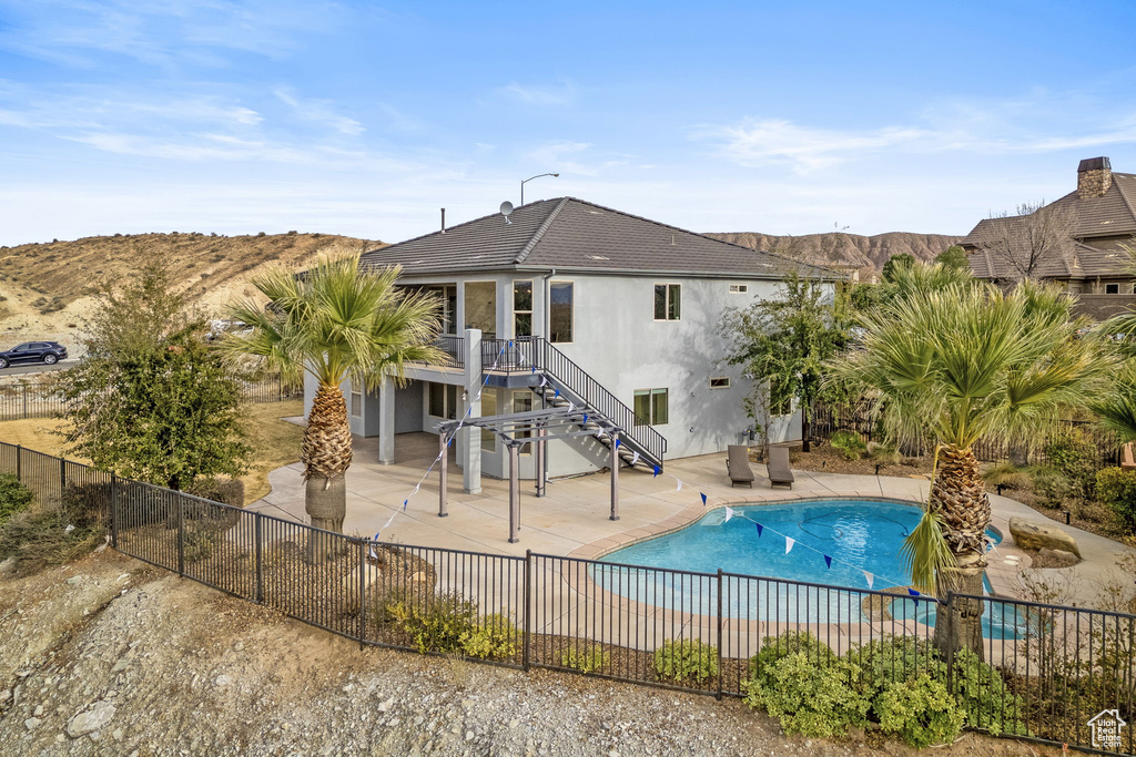 View of pool featuring a mountain view and a patio